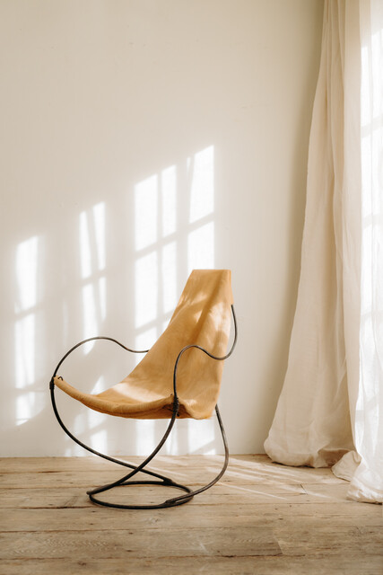 occasional iron chair .. upholstered with cowskin ...