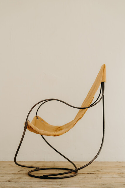 occasional iron chair .. upholstered with cowskin ...