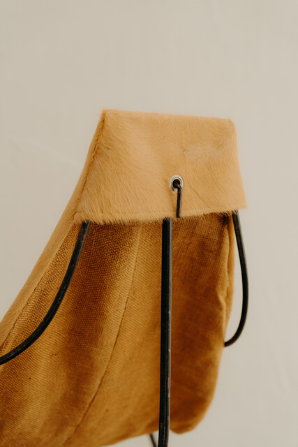 occasional iron chair .. upholstered with cowskin ...