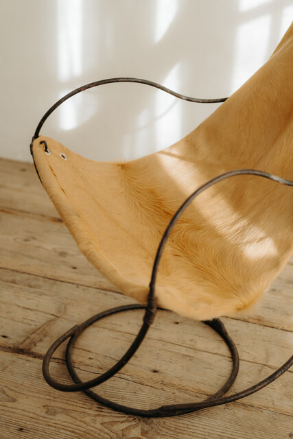 occasional iron chair .. upholstered with cowskin ...