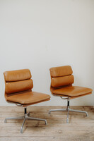 pair of cognac colored Eames chairs ...