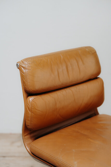 pair of cognac colored Eames chairs ...
