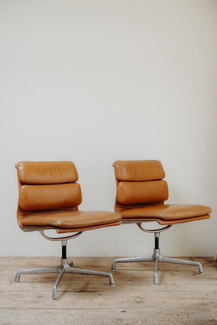 pair of cognac colored Eames chairs ...