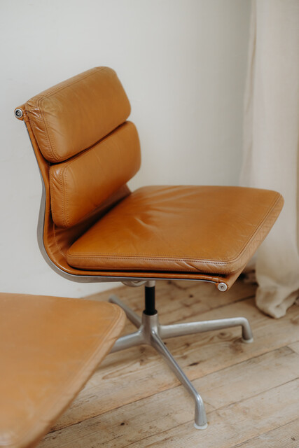 pair of cognac colored Eames chairs ...