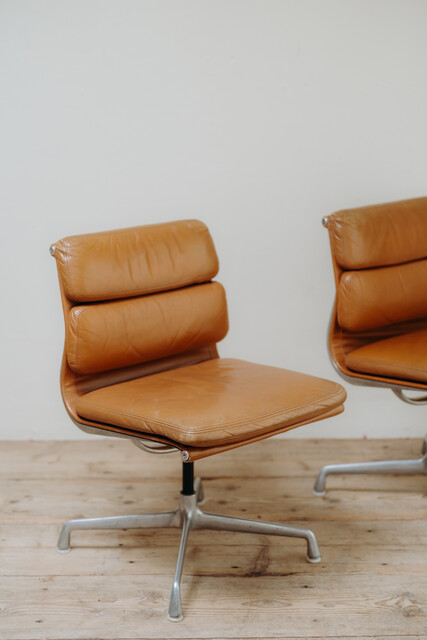pair of cognac colored Eames chairs ...