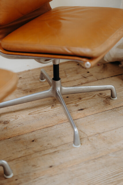 pair of cognac colored Eames chairs ...