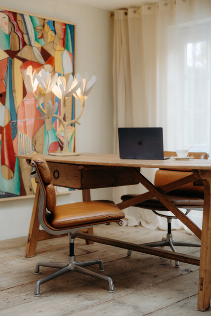 pair of cognac colored Eames chairs ...